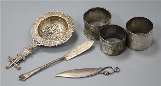 A 1930s Georg Jensen silver letter knife no. 255, a tea strainer, a butter knife and 3 serviette rings.